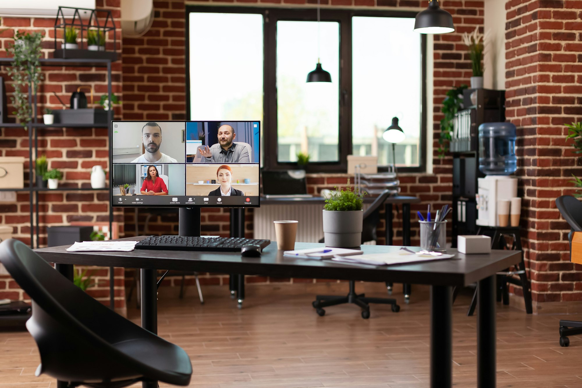 Video call communication with colleagues on computer in empty business office